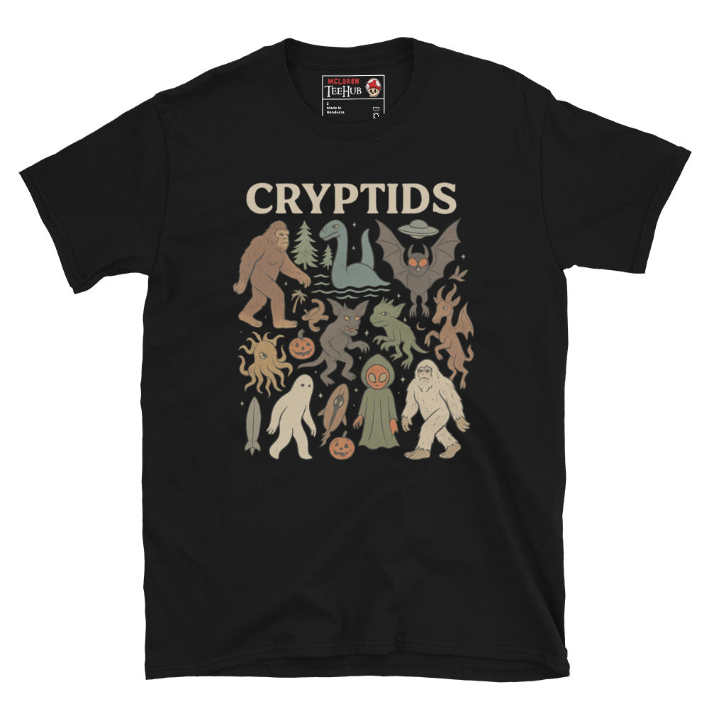 Black T-shirt featuring vintage cartoon-style illustrations of various cryptids including Bigfoot, Mothman, Loch Ness Monster, and more.