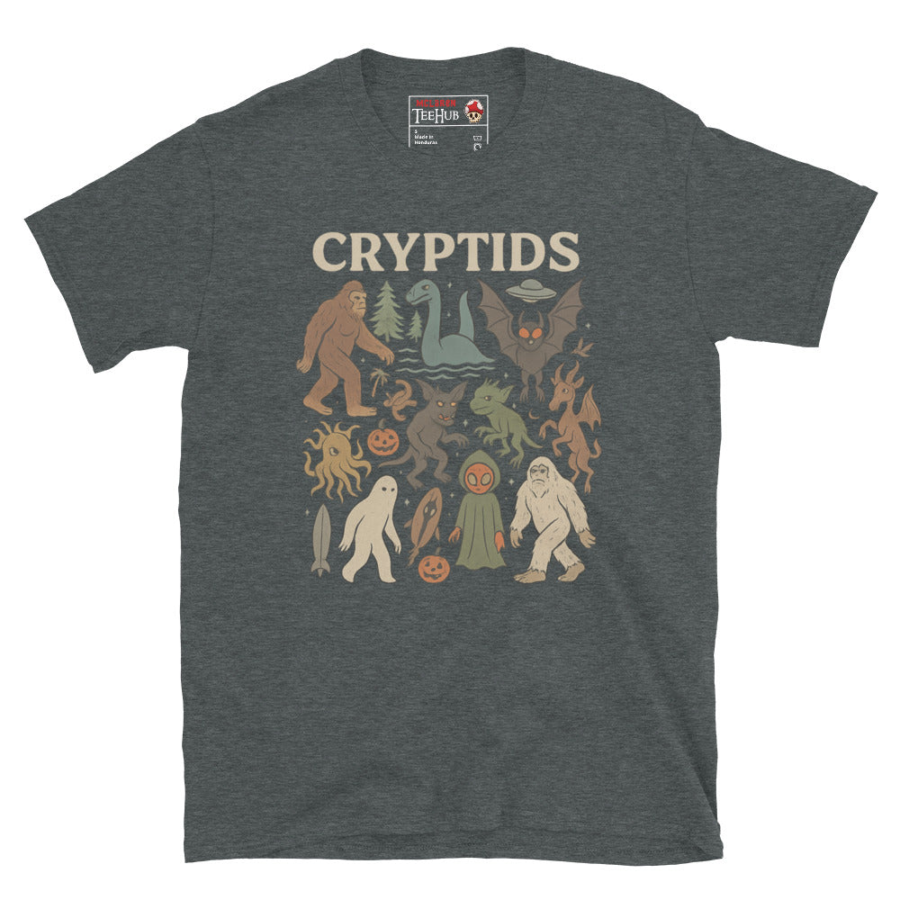 Dark Heather T-shirt featuring vintage cartoon-style illustrations of various cryptids including Bigfoot, Mothman, Loch Ness Monster, and more.
