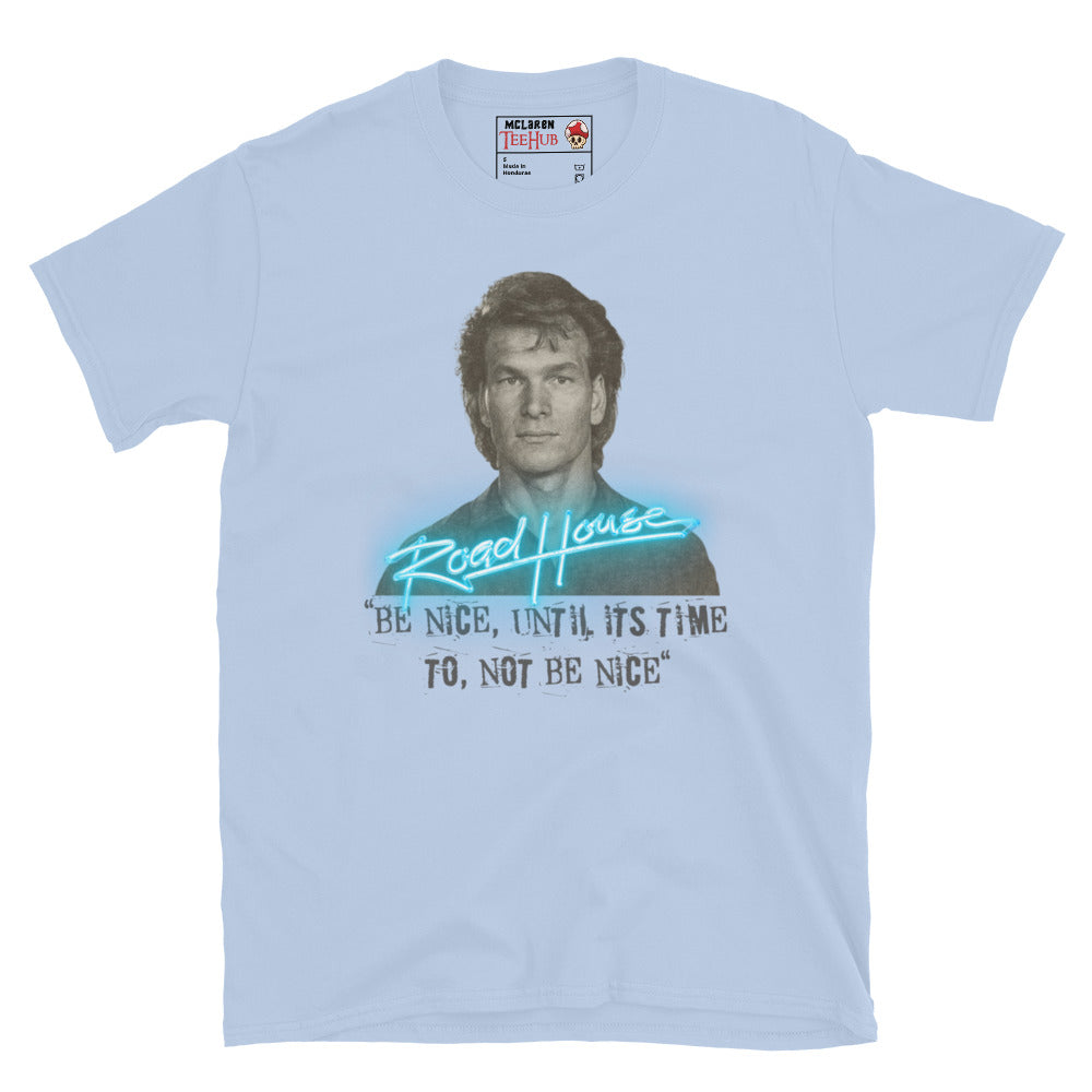 Road House Light Blue T-shirt featuring Patrick Swayze as Dalton with the quote “Be Nice Until It’s Time to Not Be Nice” in neon style.