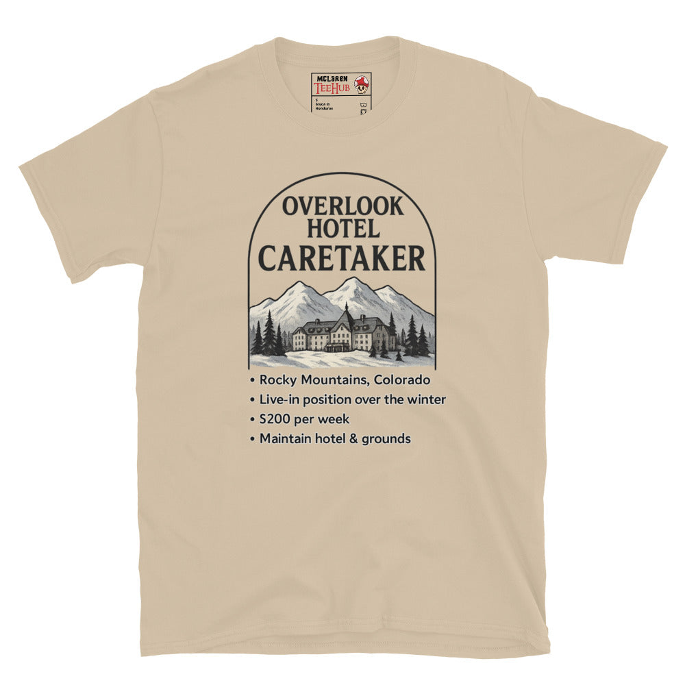 Sand T-shirt featuring a faux job ad for the Overlook Hotel caretaker position with mountains and hotel graphic, inspired by The Shining.