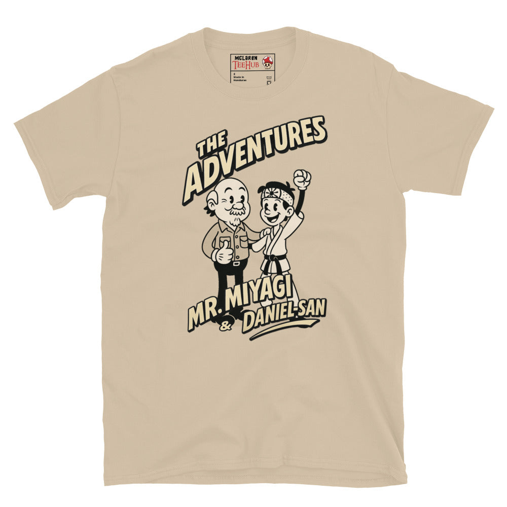 Sand T-shirt featuring a vintage cartoon design of Mr. Miyagi and Daniel-San from The Karate Kid, with the text 'The Adventures of Mr. Miyagi & Daniel-San'.