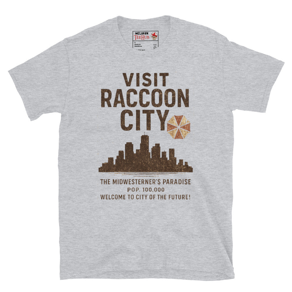 Sport Grey T-shirt with vintage-style “Visit Raccoon City” graphic featuring city skyline, Umbrella Corp logo, and distressed text inspired by Resident Evil.