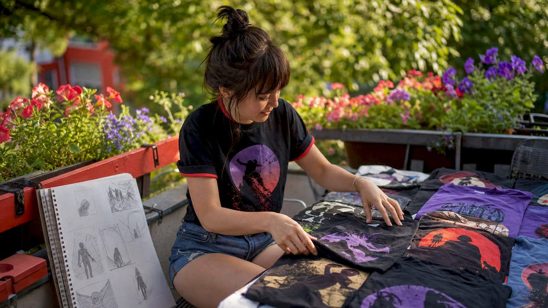 Young woman sorting blockbuster fan T-shirts