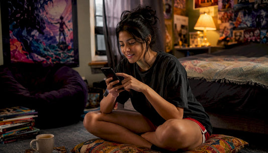 Woman browsing pop culture tees at home