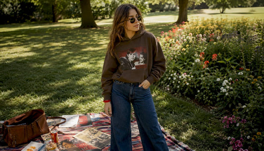 Woman modeling 70s retro film hoodie outfit outdoors