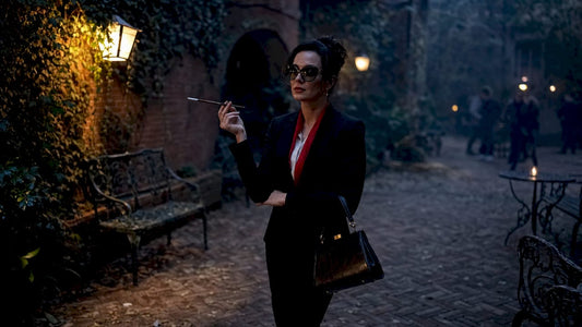 Woman in film noir outfit standing in alley