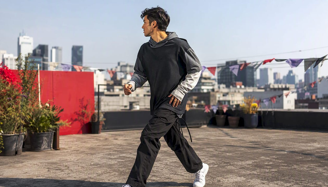 Person wearing stylish layered hoodie outdoors