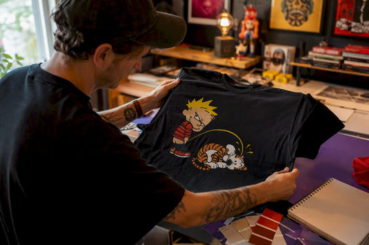 Designer inspecting parody t-shirt print detail