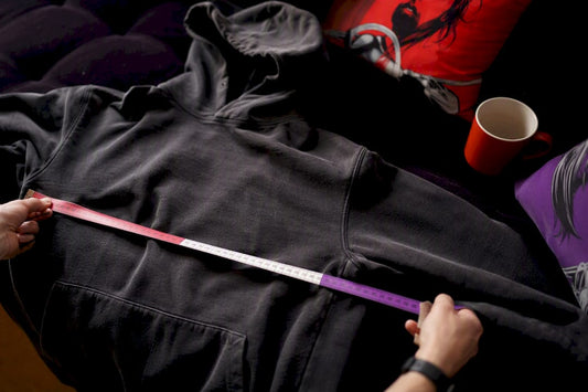 Measuring a hoodie flat on a table