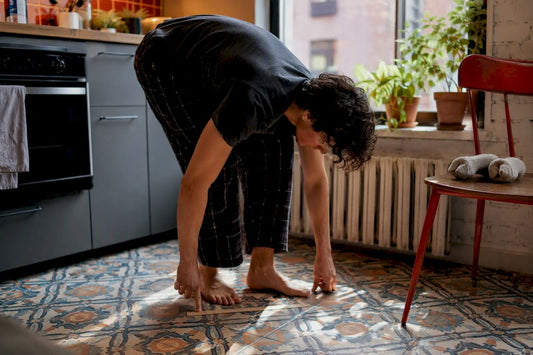 Person measuring foot length with ruler