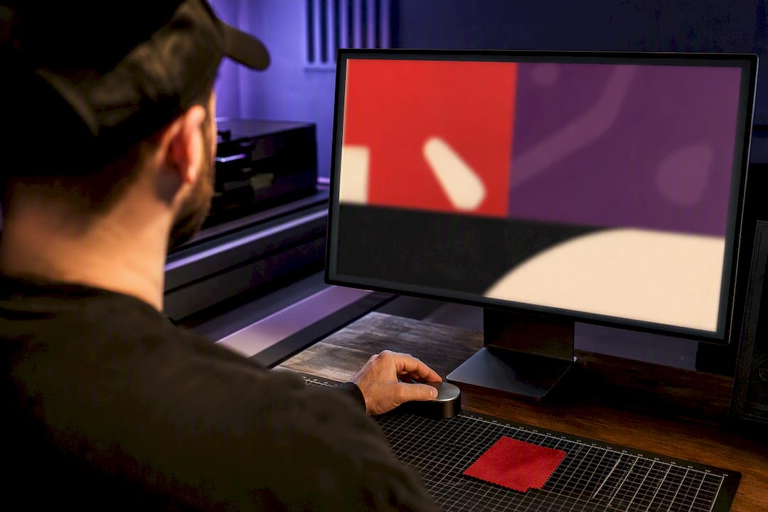 Designer reviewing print-ready artwork on monitor