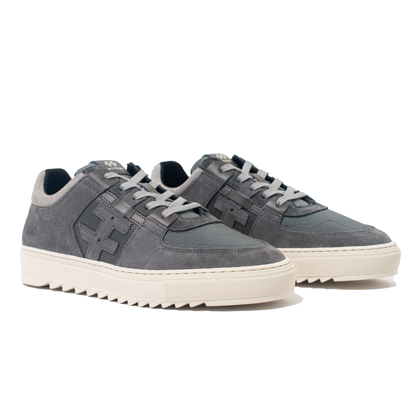 Pair of gray sneakers with white soles on a white background