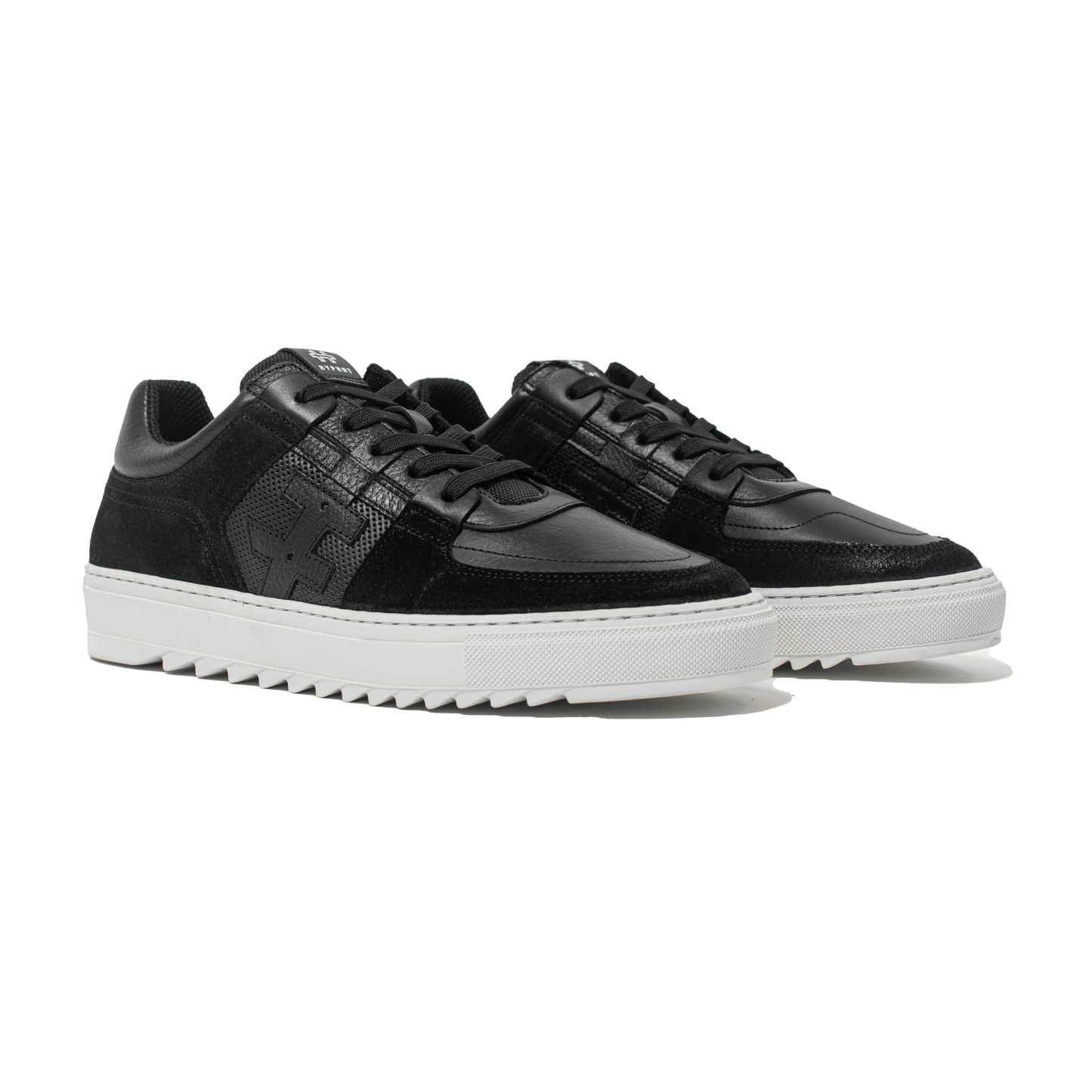 Pair of Black sneakers with white soles on a white background
