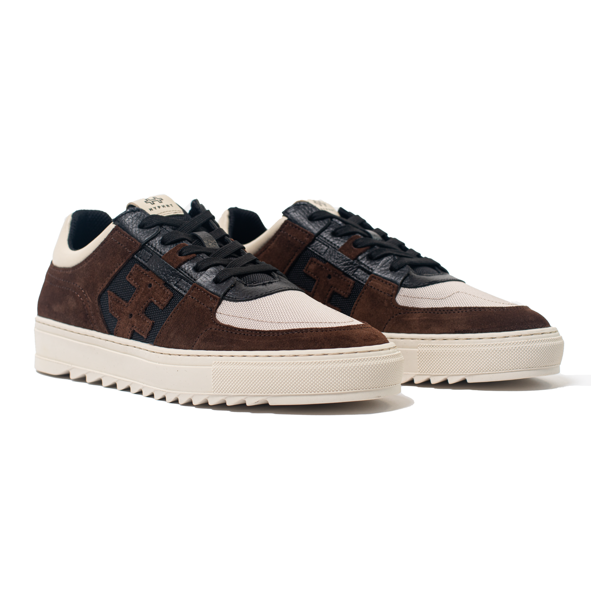 Pair of Brown and black sneakers with white soles on a white background
