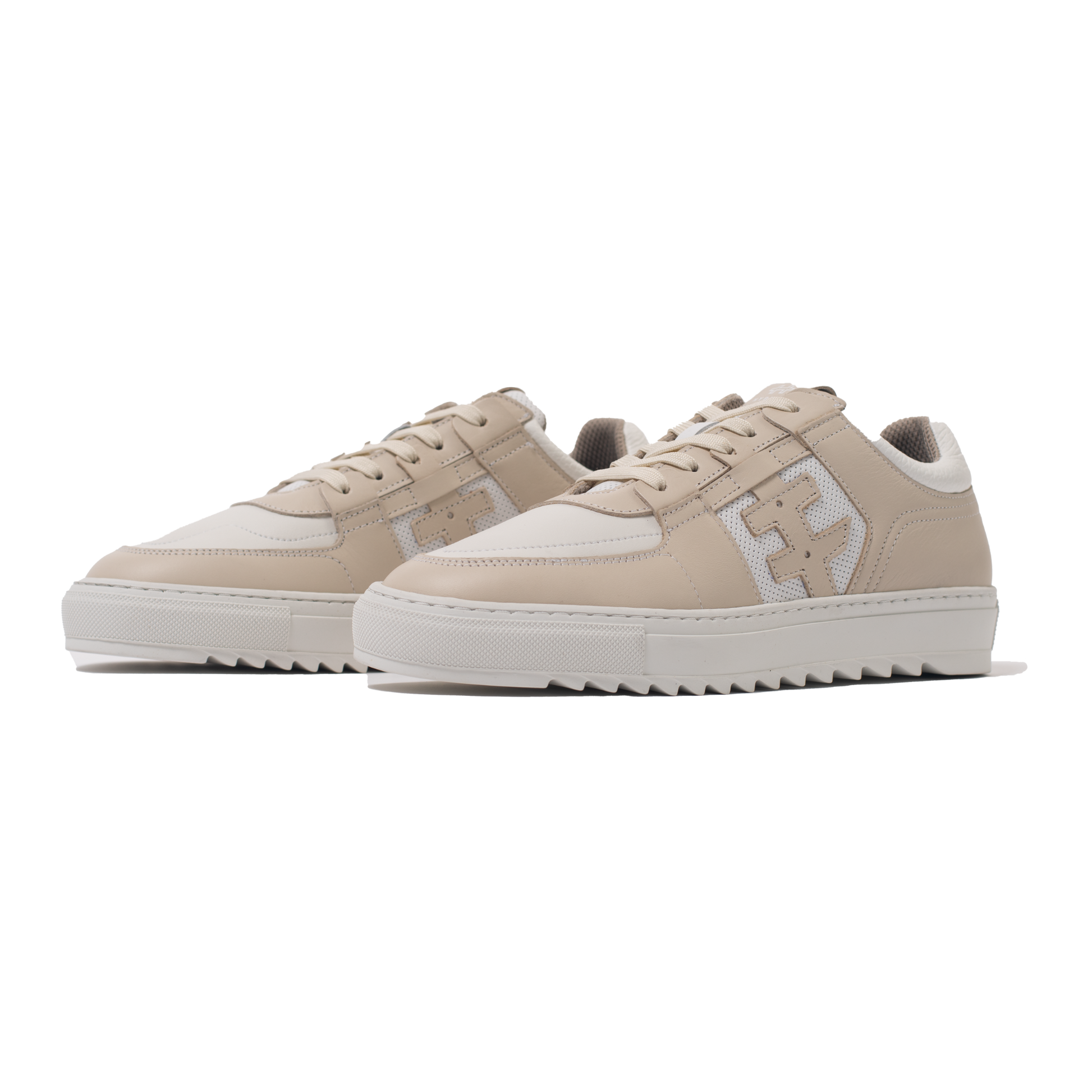 Pair of Beige sneakers with white soles on a white background