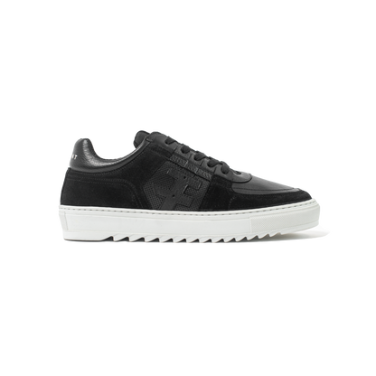 Black sneakers with white soles on a white background