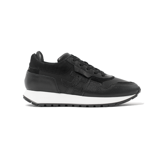 Black sneaker with white sole on a white background