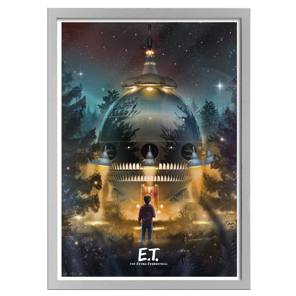 Framed movie poster of E.T. with a spaceship in a forest at night.