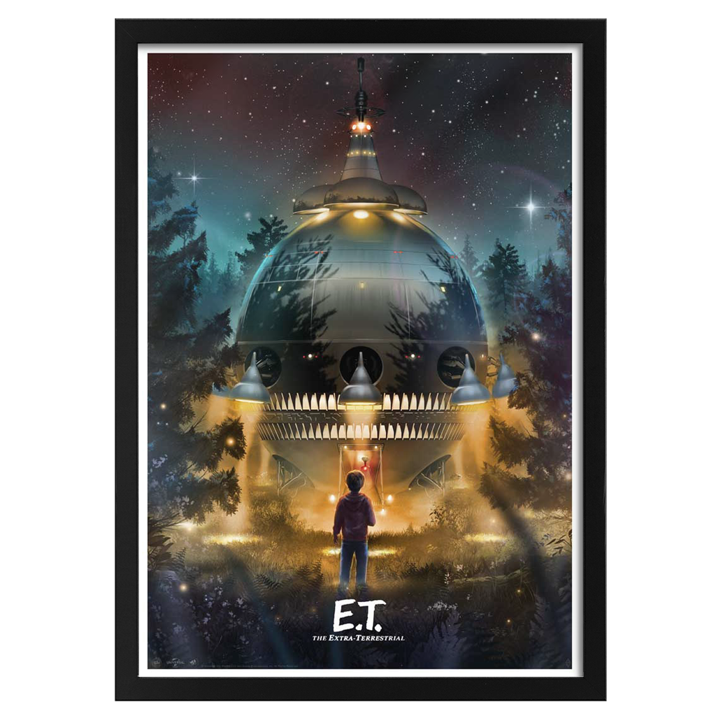 Framed movie poster of E.T. with a spaceship in a forest at night.