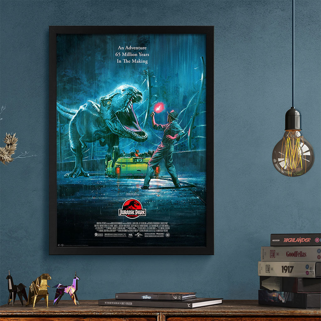 Framed movie poster of 'Jurassic Park' on a blue wall with decorative items below.