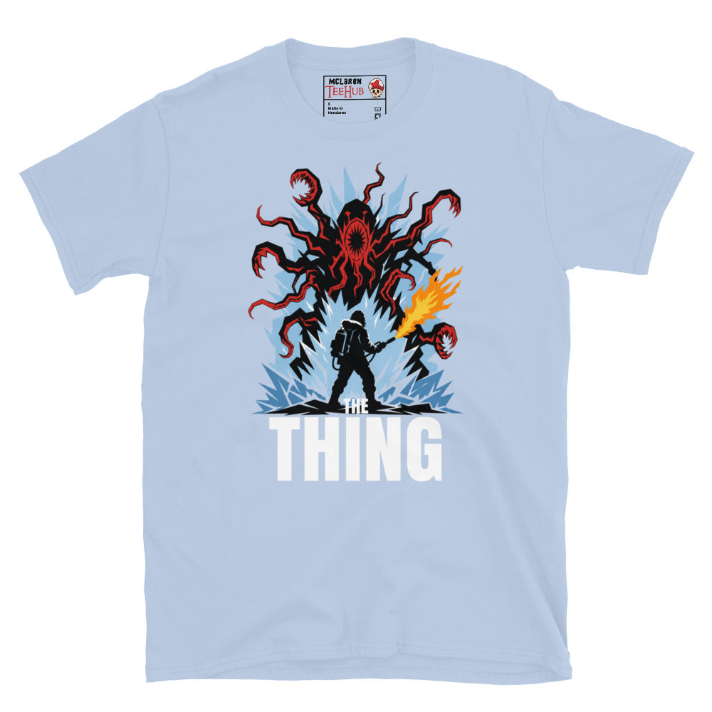 The Thing horror movie t-shirt featuring alien creature artwork and a flamethrower survivor in an Antarctic horror scene. Light Blue 
