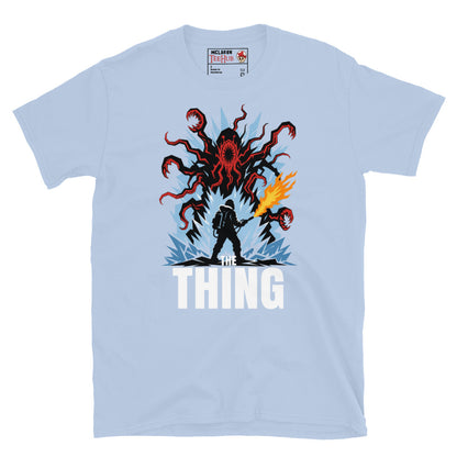 The Thing horror movie t-shirt featuring alien creature artwork and a flamethrower survivor in an Antarctic horror scene. Light Blue 