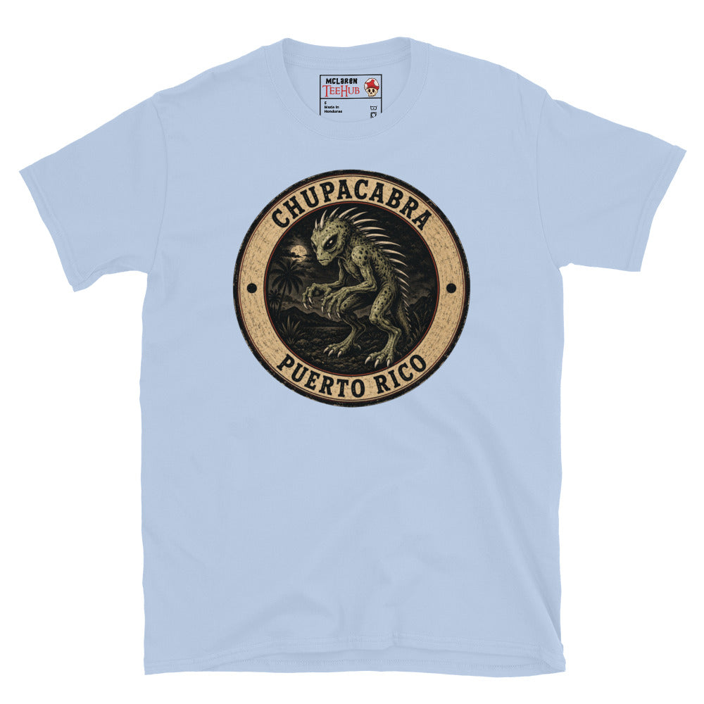Light Blue Chupacabra Puerto Rico t-shirt with vintage distressed badge featuring original reptilian Chupacabra with scaled body dorsal spines alien eyes and claws in tropical night scene.