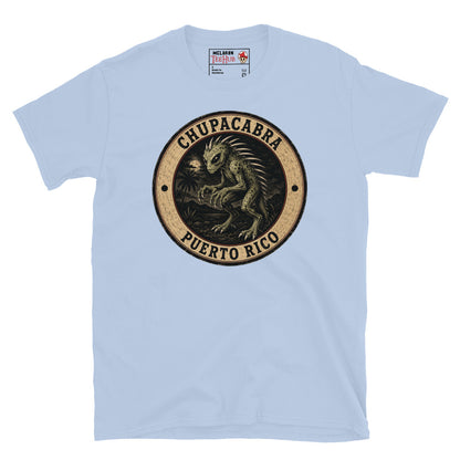 Light Blue Chupacabra Puerto Rico t-shirt with vintage distressed badge featuring original reptilian Chupacabra with scaled body dorsal spines alien eyes and claws in tropical night scene.