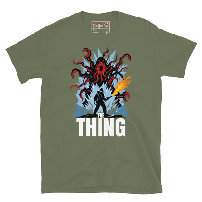 The Thing horror movie t-shirt featuring alien creature artwork and a flamethrower survivor in an Antarctic horror scene. Military Green 