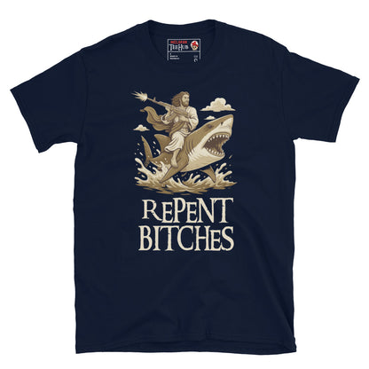 Navy T-shirt featuring an illustration of Jesus riding a shark and holding a machine gun, with the phrase “Repent Bitches” written below.