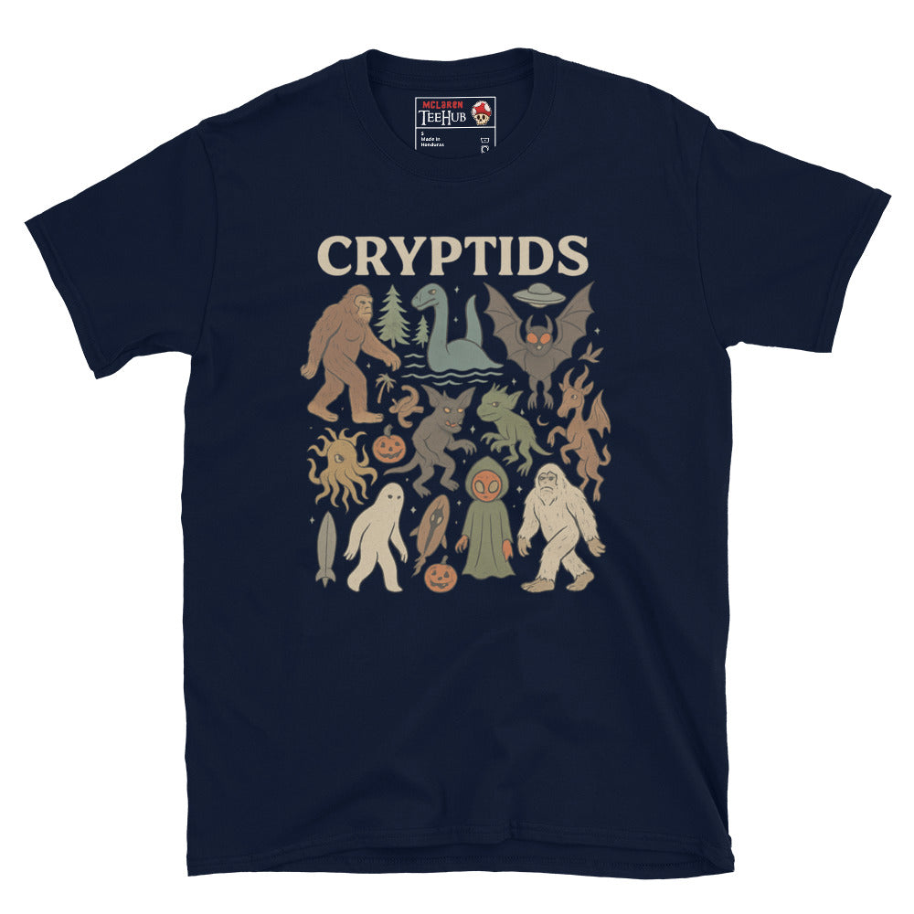 Navy T-shirt featuring vintage cartoon-style illustrations of various cryptids including Bigfoot, Mothman, Loch Ness Monster, and more.