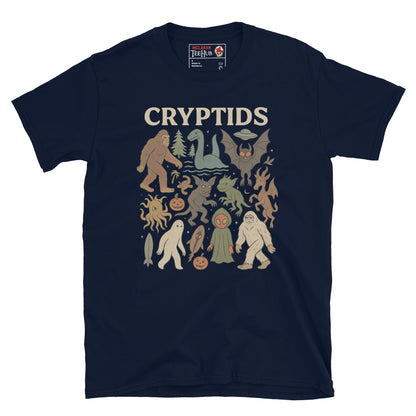 Navy T-shirt featuring vintage cartoon-style illustrations of various cryptids including Bigfoot, Mothman, Loch Ness Monster, and more.