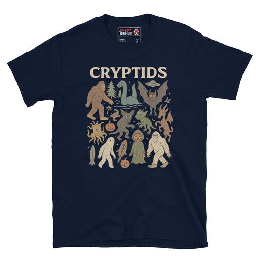 Navy T-shirt featuring vintage cartoon-style illustrations of various cryptids including Bigfoot, Mothman, Loch Ness Monster, and more.
