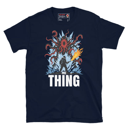 The Thing horror movie t-shirt featuring alien creature artwork and a flamethrower survivor in an Antarctic horror scene. Navy