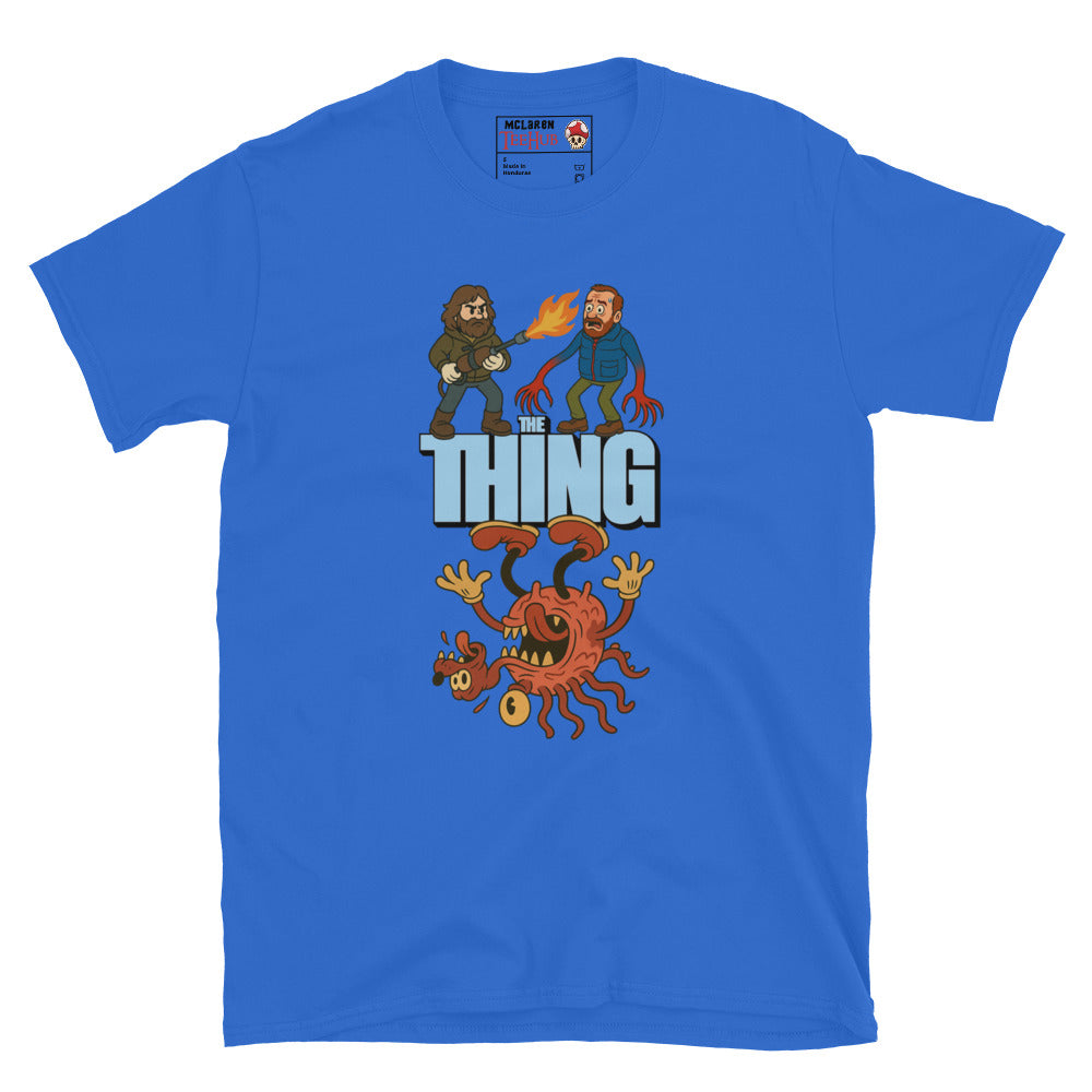 Royal blue T-shirt with a cartoon parody design of The Thing featuring MacReady with a flamethrower and a mutated creature.