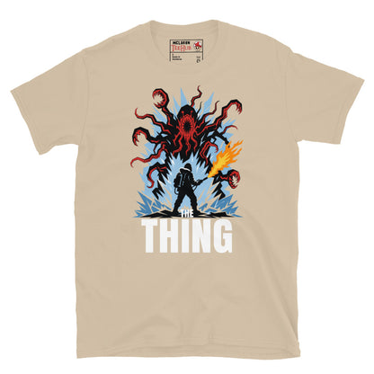 The Thing horror movie t-shirt featuring alien creature artwork and a flamethrower survivor in an Antarctic horror scene. Sand