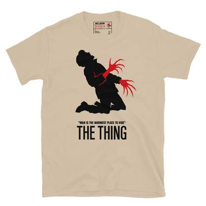 The Thing Bennings transformation t-shirt featuring minimalist horror artwork and the quote Man Is The Warmest Place To Hide. Sand