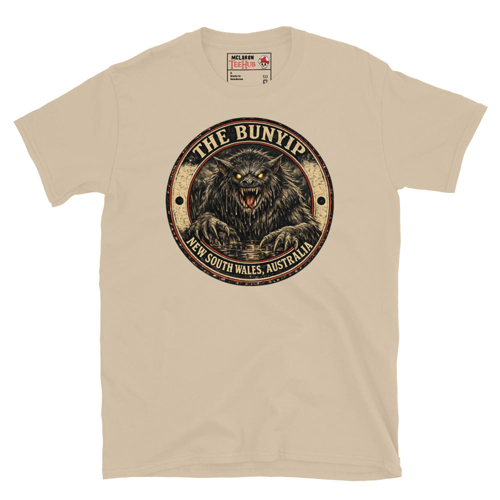 Sand colour Bunyip New South Wales Australia t-shirt with vintage distressed badge featuring shaggy dark Bunyip rising from water with glowing amber eyes savage fangs and claws.