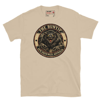 Sand colour Bunyip New South Wales Australia t-shirt with vintage distressed badge featuring shaggy dark Bunyip rising from water with glowing amber eyes savage fangs and claws.
