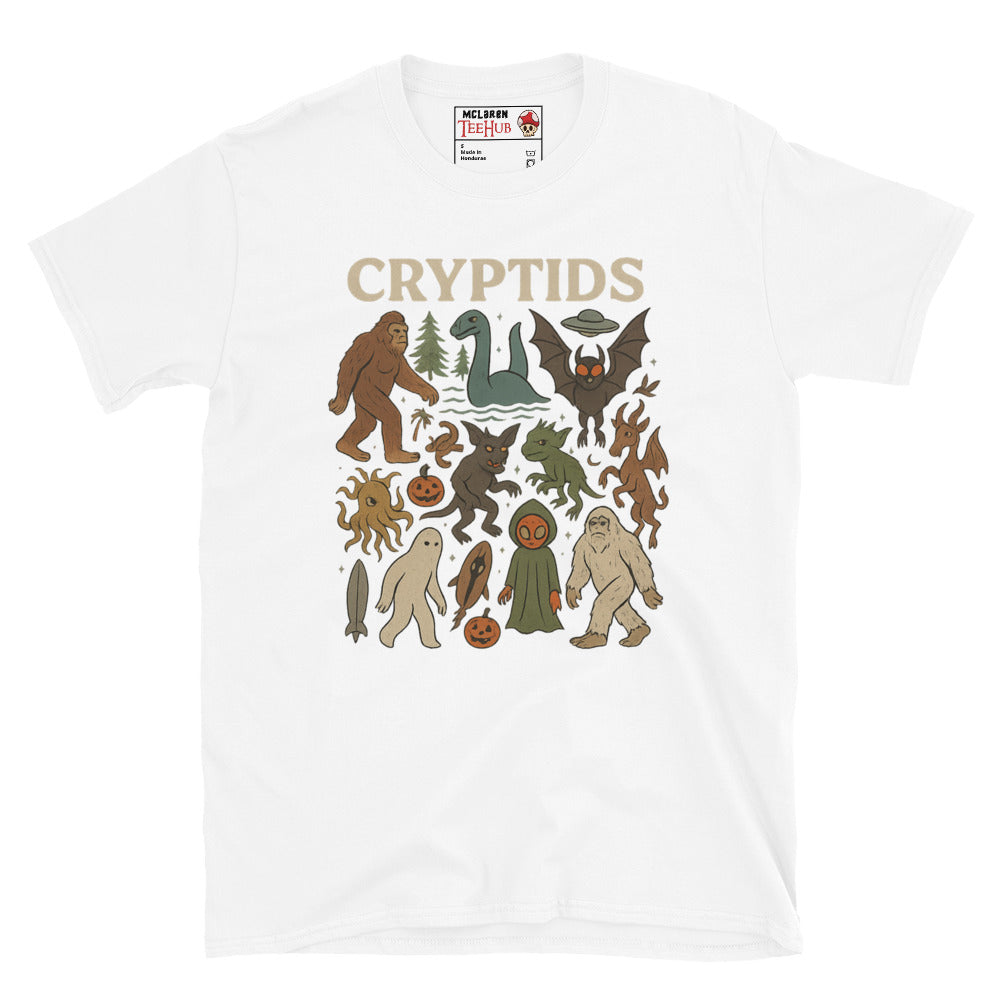 White T-shirt featuring vintage cartoon-style illustrations of various cryptids including Bigfoot, Mothman, Loch Ness Monster, and more.